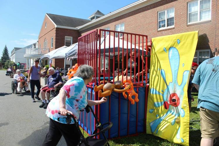 Participants painting a colorful community art installation