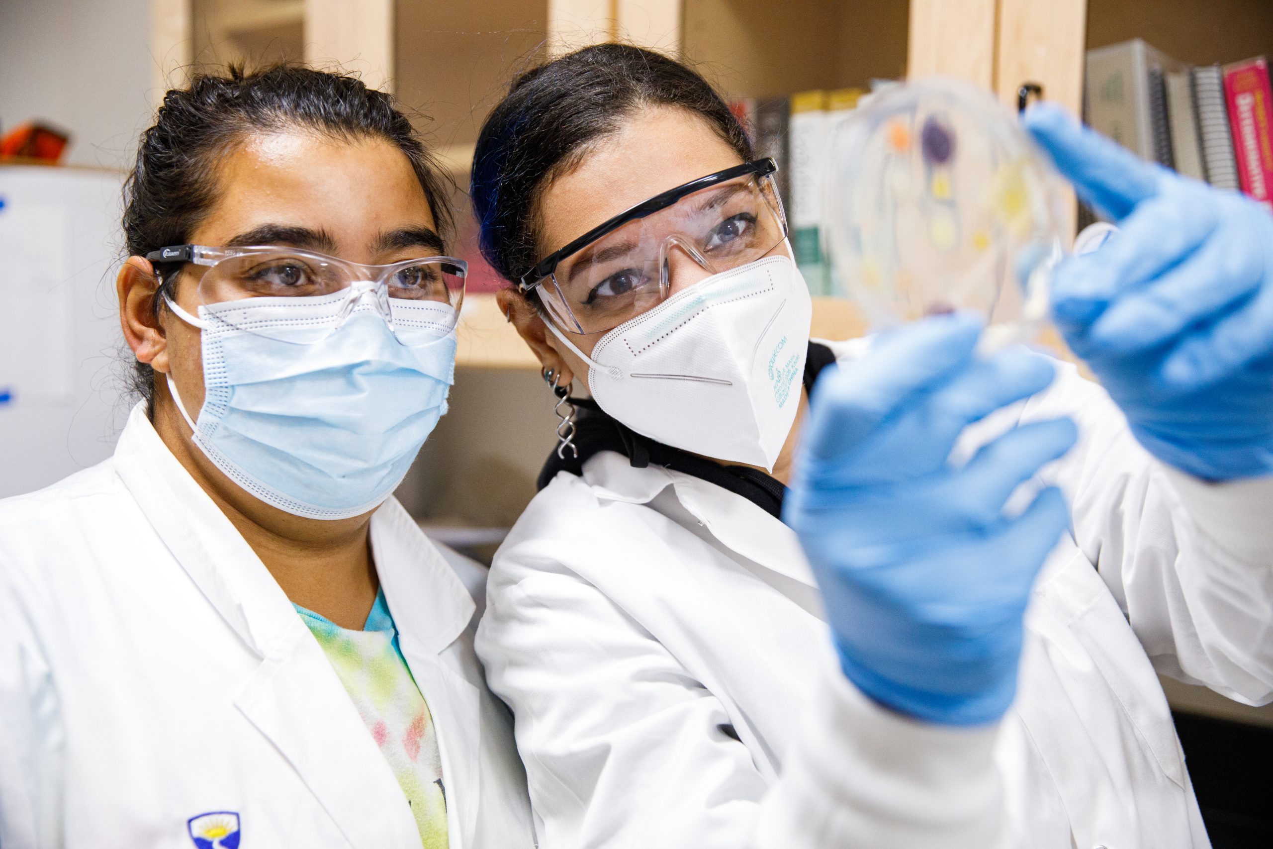 Healthcare students wearing masks and examining laboratory samples