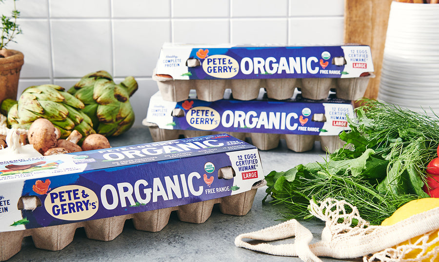 Pete and Gerry’s organic egg cartons beside fresh vegetables