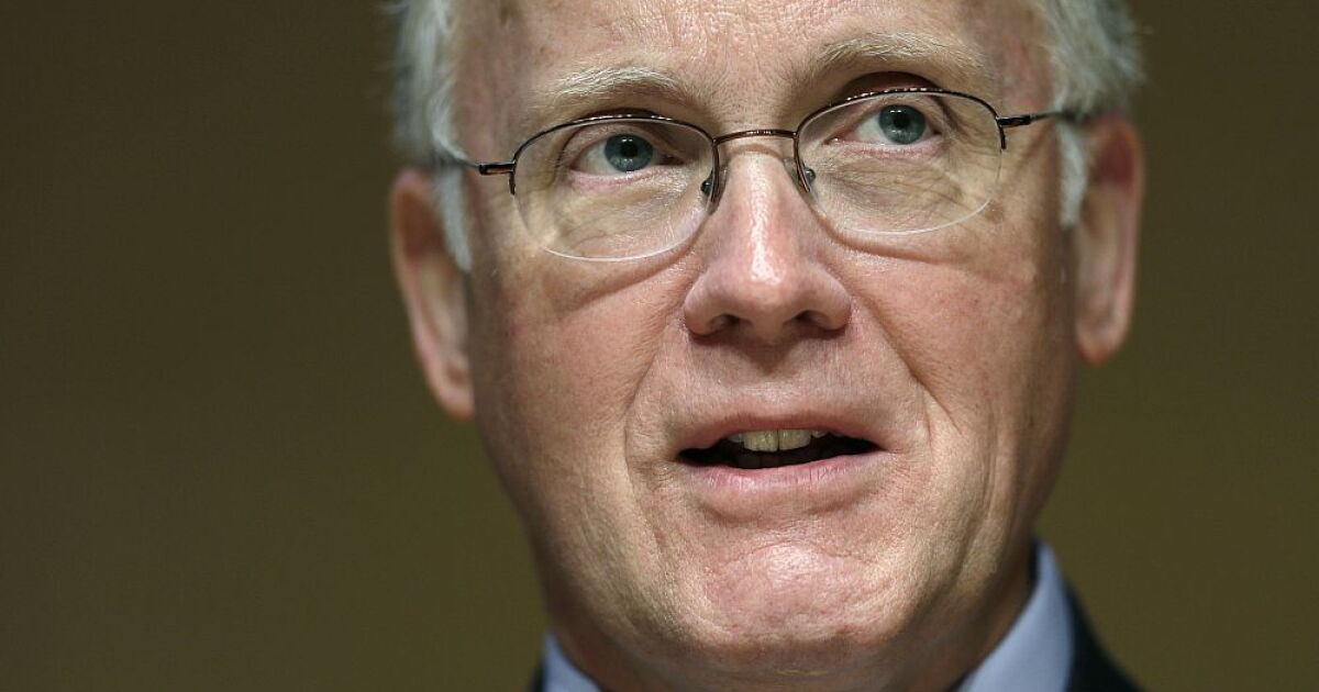 Close-up portrait of an older man wearing glasses