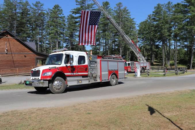 East Burke fire engines and an American flag at a community gathering