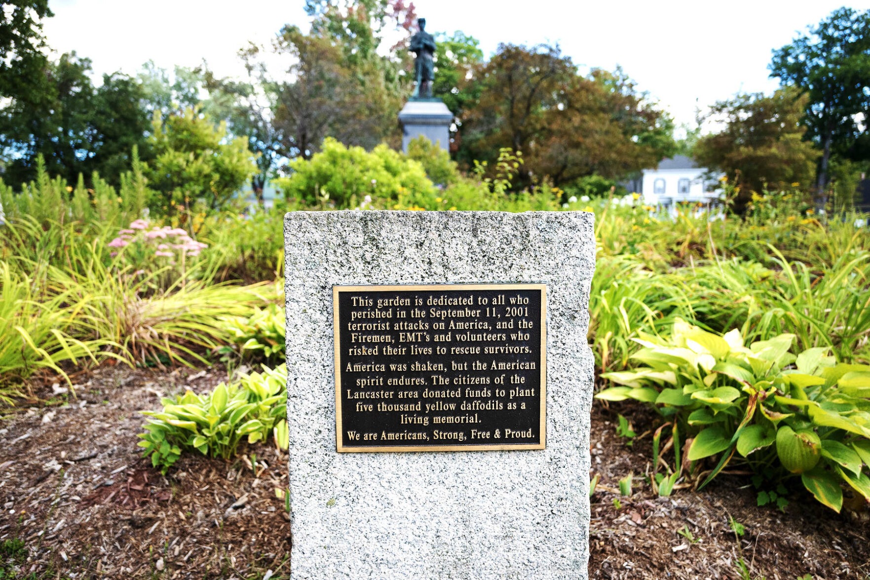 September 11 memorial plaque surrounded by garden plants