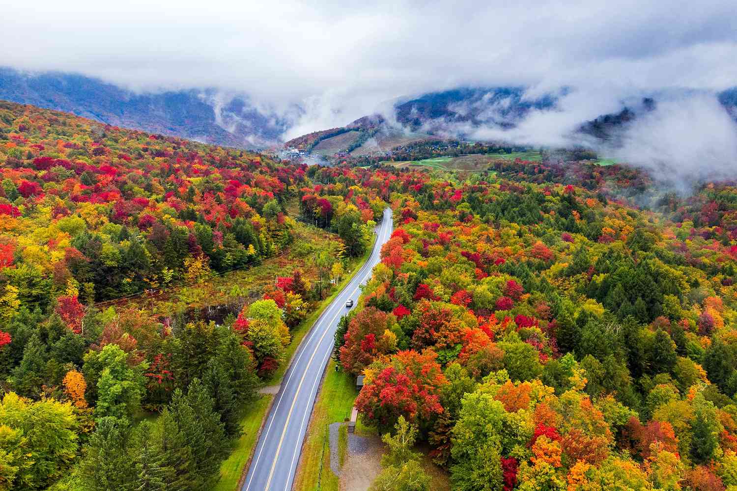 Road winding through colorful Vermont fall foliage