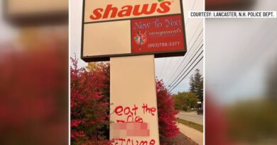 Graffiti spray-painted on a business sign along Main Street in Lancaster