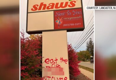 Graffiti spray-painted on a business sign along Main Street in Lancaster