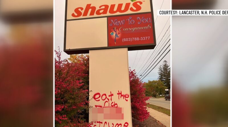 Graffiti spray-painted on a business sign along Main Street in Lancaster