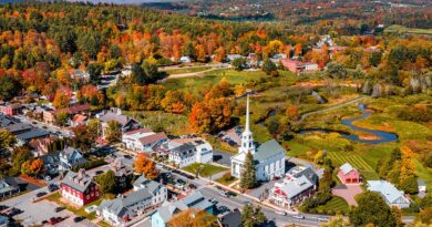 Vermont town and church steeple surrounded by fall foliage